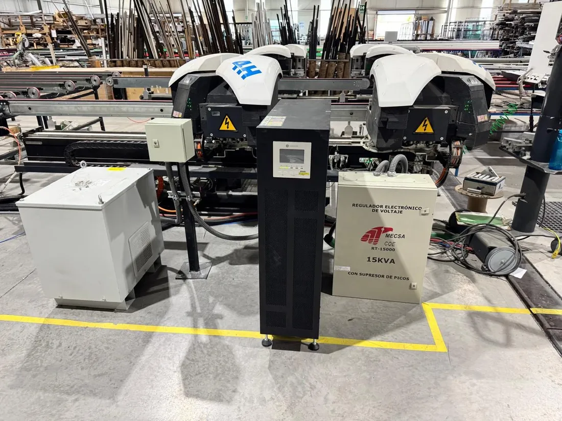 Regulador de voltaje y UPS instalados junto a una línea de producción